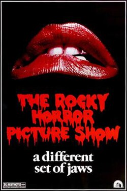 Movie poster for The Rocky Horror Picture Show. A pair of red lips fills the upper half of the frame against a black background, slightly parted with teeth visible. The title appears below in red letters with a dripping treatment. The tagline reads "a different set of jaws."