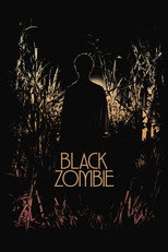 Movie poster for Black Zombie. A figure stands in silhouette in tall reeds or grass at dusk, seen from behind and turned slightly to one side. The scene is lit in dim gold and deep brown. The title appears in the lower left in white capitals stacked on two lines.