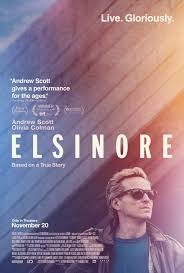 Movie poster for Elsinore. A man with light hair and sunglasses, in a dark jacket, looks off to the side in the lower right. Behind him, soft streaks of blue, pink, and orange light fill the frame. The title appears in widely spaced white capitals. Tagline: “Live. Gloriously.”