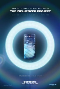 Movie poster for The Influencer Project. A phone stands upright at the center of a glowing white ring light against a dark background, its screen showing a blurred figure. The tagline "Where do you hide when everyone is watching?" runs below the title. Only in theaters October 2.