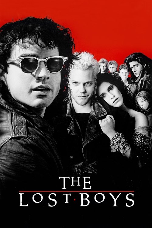 Movie poster for The Lost Boys. About eight young people appear in black and white against a red background. In front, a curly-haired man wears sunglasses. Beside him, a man with spiky platinum hair smirks as a dark-haired woman leans on his shoulder. The title appears in white serif capitals.