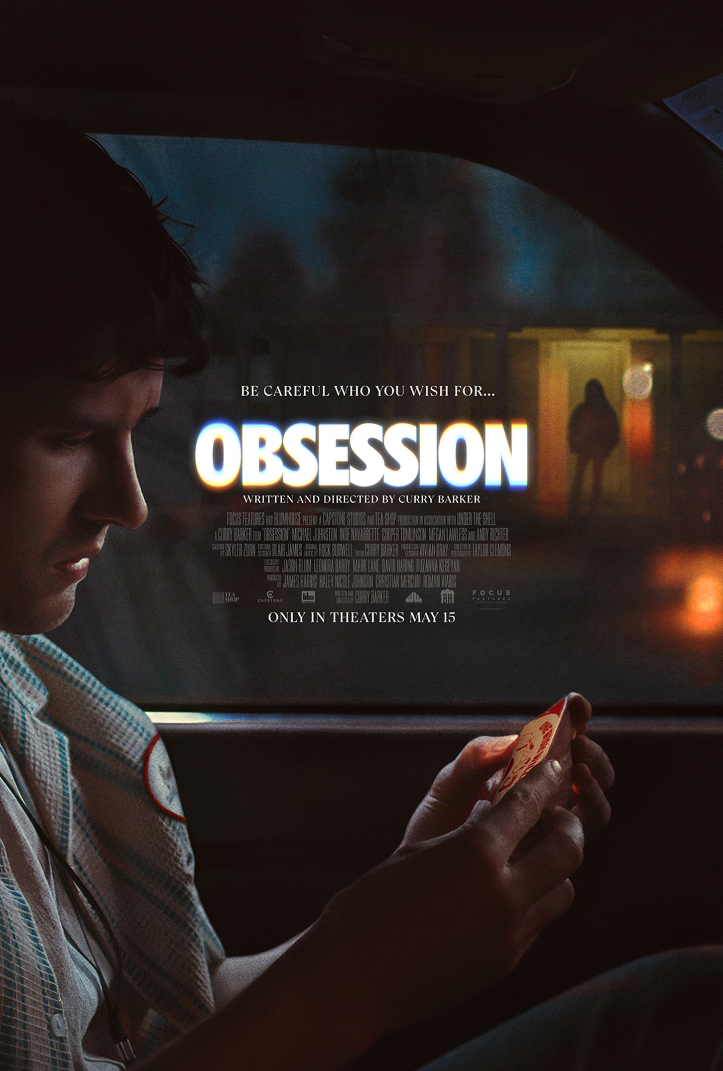 Movie poster for Obsession. A young man sits in a parked car at night looking down at a small red object in his hands. Through the window behind him, a figure stands in the lit doorway of a house across the street. The title glows in white capitals above the tagline "Be careful who you wish for." Only in theaters May 15.