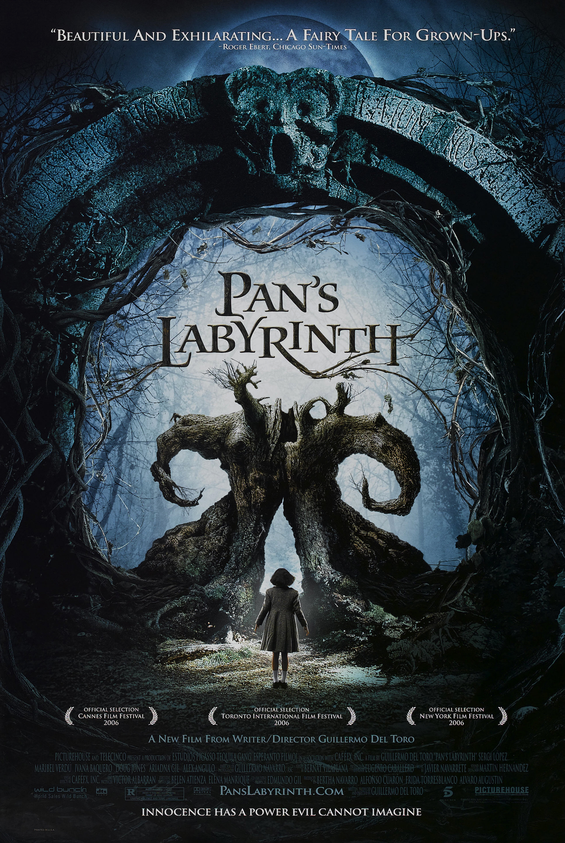 Movie poster for Pan's Labyrinth. A girl in a dark coat stands alone with her back to the camera, facing a huge gnarled tree whose two curled roots rise like horns. The scene is framed by a vast stone arch carved with a face and tangled with bare branches. The title appears at the center in pale lettering. The tagline "Innocence has a power evil cannot imagine" runs along the bottom.