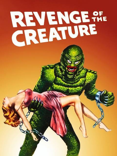 Movie poster for Revenge of the Creature. In a painted illustration, a green, scaly, fish-like monster with red lips and broken chains dangling from its wrists carries a limp red-haired woman in a pink dress. The background glows orange and red. The title appears in bold white letters.