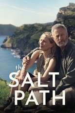 Movie poster for The Salt Path. A woman and an older bearded man stand close together on a coastal clifftop, both looking off to the side, with green headlands and the sea behind them. The title appears in white capitals across the lower third.