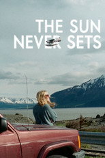 Movie poster for The Sun Never Sets. A woman with long blonde hair sits on the roof of a red pickup truck parked at the roadside, looking out over a wide inlet toward snow capped mountains under a pale overcast sky. The title appears in white capitals at the top.