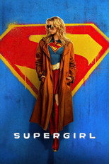 Movie poster for Supergirl. A blonde woman in sunglasses and a long tan trench coat stands with her hands in her pockets against a blue wall painted with a large red and yellow Superman shield. A blue and red suit, gold belt, and tall red boots show beneath the coat. The title reads Supergirl in bold white letters.