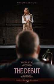 Movie poster for The Debut. A woman in a pale blouse and long skirt stands alone on a dark stage under a spotlight, facing forward. In the foreground, the back of a man's head is visible in silhouette, watching her. The title appears near the bottom in white capitals.