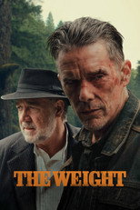 Movie poster for The Weight. Two older men stand outdoors in front of misty evergreen trees. The man in front has a scraped, bloodied face and wears a worn denim jacket; behind him at left stands a man in a brimmed hat, slightly out of focus. The title appears at the bottom in gold capitals.
